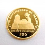 犬小屋でくつろぐスヌーピーとウッドストックが描かれたピーナッツ50周年記念純金コイン（50ドル金貨）